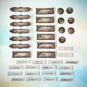 May include: A collection of vintage-style stickers and labels with various text, including "Journal," "Memories," and "Timeless." The stickers feature ornate frames and decorative elements in shades of brown and beige, suitable for scrapbooking or journaling.