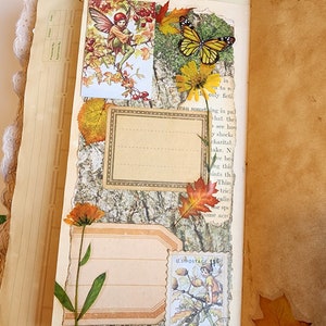 May include: A scrapbook page with a collage of fall-themed images, including a fairy, a butterfly, leaves, and flowers. The page is decorated with a vintage-style border and a U.S. postage stamp.
