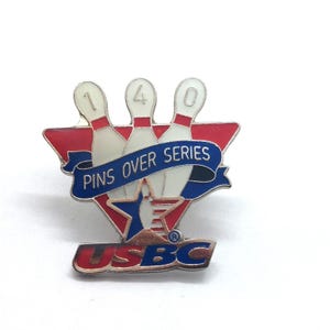 May include: A bowling pin badge in red, white, and blue. The pin shows three white bowling pins with the numbers 1, 4, and 0. The text "PINS OVER SERIES" is on a blue banner. The pin also has the text "USBC".