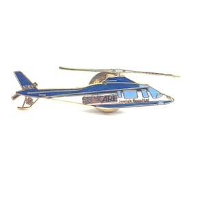 May include: A gold-colored pin of a blue and white helicopter with the words "SKYCARE Jewish Hospital" on the side.