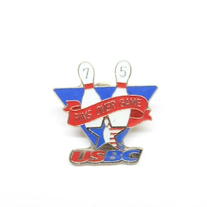 May include: A red, white and blue bowling pin pinback button with the text "USBC" and "PINS OVER GAME".