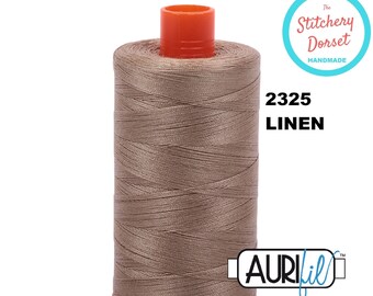 May include: A spool of Aurifil thread in the color 2325 Linen. The thread is a light brown color and is wound on a white spool with a red and orange plastic top. The spool is labeled with the Aurifil logo and the color number and name.