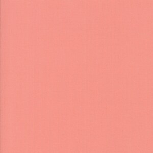 May include: A solid coral-colored fabric with a subtle woven texture. The image displays a flat lay of the material, showcasing its uniform color and surface detail. The fabric appears to be a medium weight, suitable for various sewing projects.