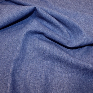 Tessuto denim lavato da 8 once &#39;Shade Medium - Denim Blue&#39;.  58 pollici (145 cm) di larghezza. 100% Cotone. Peso 287 gsm. Per abbigliamento, artigianato e arredamento.
