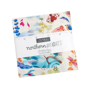 May include: A stack of square fabric swatches featuring a cream background with colorful illustrations of moths, birds, and plants. A white paper band wraps around the center, displaying the text "northern BRIGHTS" and a 9-inch ruler.
