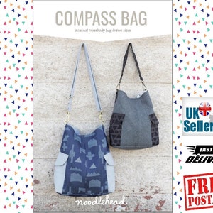 May include: A sewing pattern for a "Compass Bag" in two sizes. The pattern is for a casual crossbody bag. The image shows two bags, one blue and one gray, both with a flap pocket.