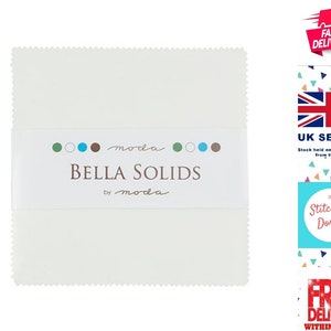 May include: A bundle of white Bella Solids fabric squares, presented with a white band displaying the brand name and logo. The fabric has a scalloped edge. The packaging includes the text "BELLA SOLIDS by moda".