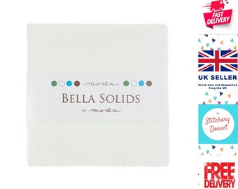May include: A stack of white Bella Solids fabric squares, neatly packaged with a white band featuring the brand name and logo. The fabric has a textured edge. The packaging includes the text "BELLA SOLIDS by moda".