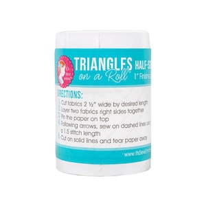 May include: White cylindrical container with a blue and pink label. The label reads "Triangles Half-Square on a Roll" and includes instructions for using the product. The instructions include cutting fabrics 2 1/2 inches wide by the desired length, layering two fabrics right sides together, pinning the paper on top, sewing on dashed lines using a 1.5 stitch length, and cutting on solid lines and tearing the paper away.