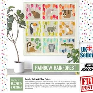 Peut inclure: Un patron de quilt sampler coloré intitulé "Rainbow Rainforest" présentant neuf blocs avec divers animaux de la forêt amazonienne. Le motif comprend un toucan, un paresseux, un jaguar, etc. Le patron est d'Elizabeth Hartman.