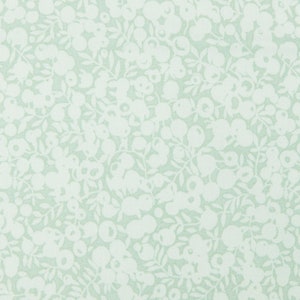 May include: A light green fabric with a white floral pattern. The pattern is a repeating design of small flowers and leaves.