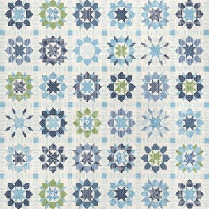 May include: A patchwork quilt featuring a repeating pattern of star and floral designs in shades of blue and green. The quilt has a cream-colored background with a grid pattern, and the star designs are made of various fabrics.