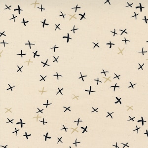 May include: A beige fabric with a repeating pattern of black and gold crosses. The crosses are hand-drawn and vary in size and shape.