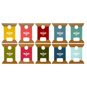 May include: A collection of ten colorful, decorative spools. Each spool features a different color, including yellow, coral, red, blue, teal, green, pink, olive, navy, and light blue. A white bee graphic is centered on each spool.
