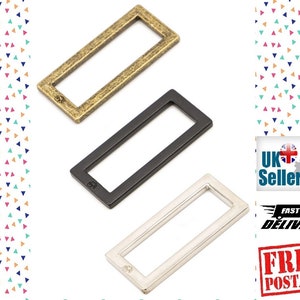 May include: Three metal rectangular slider buckles in gold, black, and silver. The buckles are approximately 2 inches long and 1 inch wide.