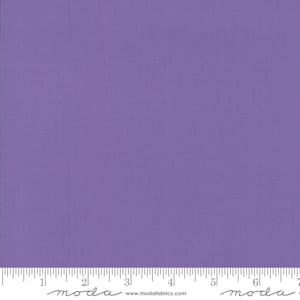 May include: A solid purple fabric swatch with a ruler showing measurements in inches.