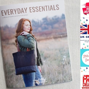 May include: A book titled "Everyday Essentials" with a collection of 5 modern accessories to sew and love. The book cover features a woman wearing a green jacket and blue jeans, holding a black and blue tote bag with brown straps. The book cover also features the text "noodlehead ANNA GRAHAM".