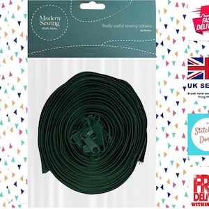 May include: A dark green bias tape, tightly coiled, with a header reading "Modern Sewing starts here... Really useful sewing notions". Ideal for sewing projects, the tape is ready to use.