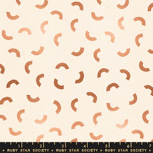 May include: A white fabric with a repeating pattern of copper-coloured half-circle shapes. The fabric has a subtle texture.