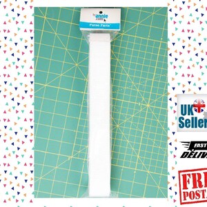 May include: White elastic strap for purse making, packaged on a green cutting mat with the text "by annie.com Purse Parts".