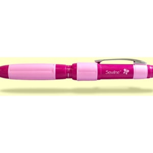 May include: A pink and purple sewing marking pen with a retractable tip and a built-in ruler. The pen has a butterfly logo and the text "Sewline" printed on the side.