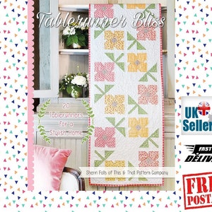 May include: A book cover featuring a colorful quilt with a floral design. The title of the book is "Tablerunner Bliss" and the subtitle is "20 Tablerunners for a Stylish Home". The book is by Sherri Falls of This & That Pattern Company.