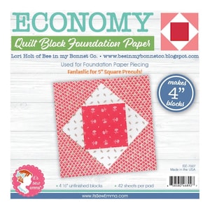 May include: A pink and white quilt block foundation paper pad with the text "ECONOMY Quilt Block Foundation Paper" and "Lori Holt of Bee in my Bonnet Co. www.beeinmybonnetco.blogspot.com". The pad makes 4" blocks and has 42 sheets per pad.