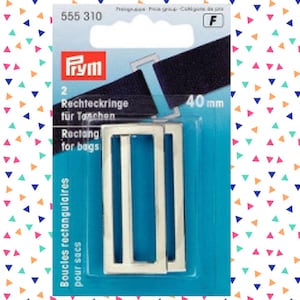 May include: Two silver rectangular metal buckles for bags or straps, 40 mm in size, packaged on a blue and white card with the Prym brand logo and the text "Rechteckringe für Taschen" and "Rectang for bags".