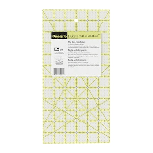 May include: A yellow 15.24 cm by 30.48 cm non-slip ruler with a grid pattern and markings for quilting, sewing, and crafts. The ruler has a clear plastic surface and a non-slip backing. The text "Omnigrip" is printed on the ruler.