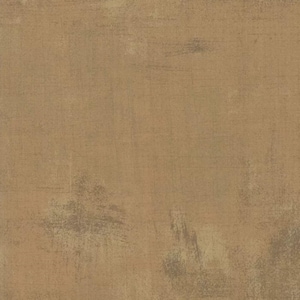 May include: A textured brown fabric with a subtle distressed look. The fabric has a slightly rough feel and a warm, earthy tone.