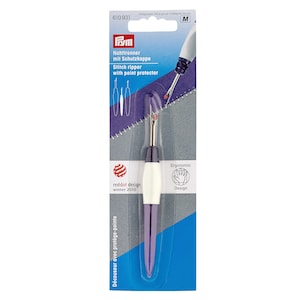 May include: Purple and white stitch ripper with a point protector. The packaging features the text "Stitch ripper with point protector" and "reddot design winner 2010".