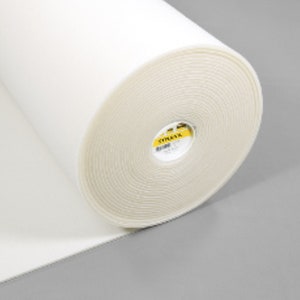 May include: A white roll of interfacing fabric with a yellow label that says "Vilene" on it.