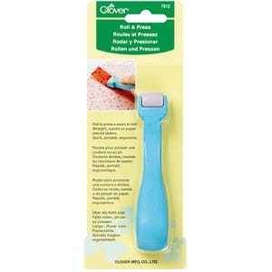 May include: A light blue Clover Roll & Press sewing tool with a small lavender roller at the top, packaged on a yellow and green card. The packaging includes the text Roll & Press, 7812, and instructions for pressing seams or folds on fabric.