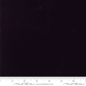 May include: A solid black fabric swatch with the text "moda" and "www.modafabrics.com" printed on a ruler at the bottom.