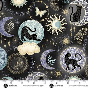 May include: A black fabric featuring a celestial pattern with black cats, crescent moons, suns, stars, and butterflies. The design includes swirling blue and gold motifs, clouds, and botanical elements. A ruler at the bottom shows 18 cm.