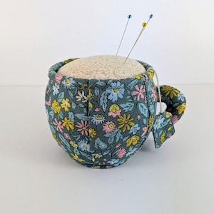 Liberty Teacup Pin Cushion(C). 8cm wide x 6cm high + Handle. Beautiful Teacup pin cushion from Liberty Fabrics, A Liberty Craft Club Product