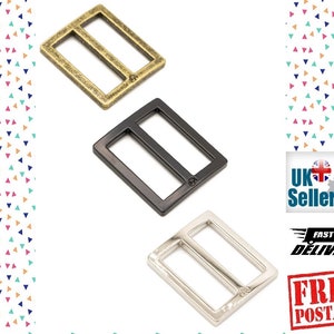Peut inclure: Trois boucles coulissantes en métal dans différentes finitions : or, noir et argent. Les boucles sont rectangulaires avec une barre centrale et deux trous de chaque côté.
