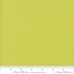May include: Solid lime green fabric with a subtle texture. The fabric is measured in inches with a ruler that says "moda" at the 2-inch and 6-inch marks.