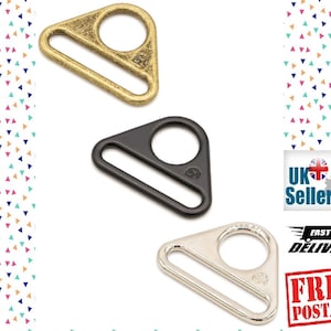 May include: Three triangle-shaped metal slider buckles in gold, black, and silver. Each buckle has a round hole and a flat bar.
