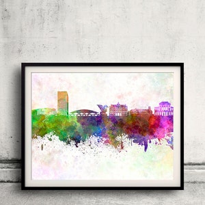 May include: A watercolor painting of a city skyline with a tall building, a bridge, and several other buildings. The painting is done in shades of blue, green, purple, and pink, with a white background.