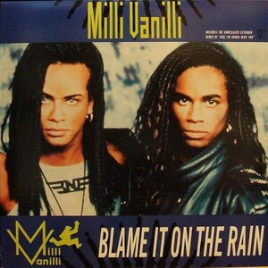 May include: A music album cover featuring two men with long dreadlocks. The album title is "Blame It On The Rain" and the artist is "Milli Vanilli".