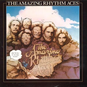 May include: Album cover for The Amazing Rhythm Aces. The cover features a group of men with stylized faces, set against a backdrop of a blue sky with clouds. The album title and band name are prominently displayed in a vintage font.
