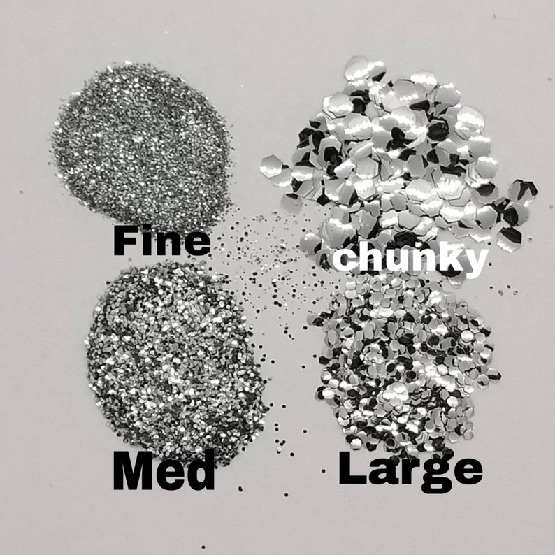 May include: Four piles of silver glitter, labeled "Fine", "Med", "Large", and "chunky".