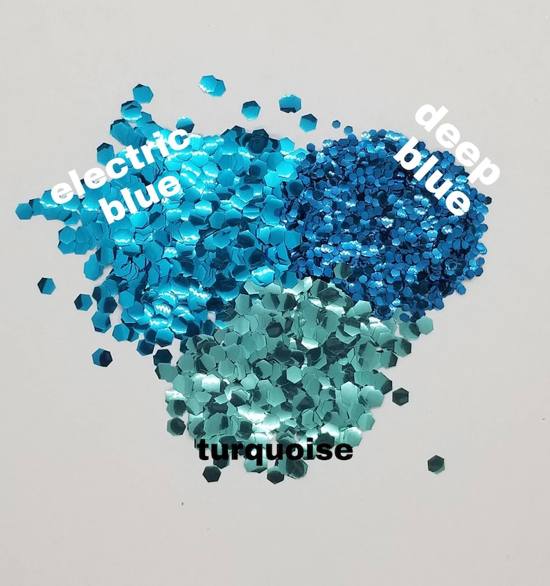 May include: A close-up of three different shades of blue glitter: electric blue, deep blue, and turquoise.