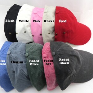 May include: A collection of baseball caps in various colors, including black, white, pink, khaki, and red. Additional colors are blue jeans, denim, faded olive, faded red, and faded black. Each cap has a curved brim and a button on top.