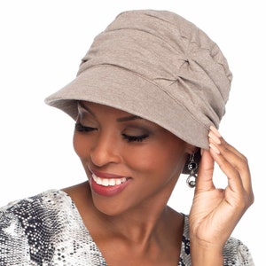 May include: A brown slouchy hat with a wide brim. The hat is made of a soft, comfortable fabric and has a casual, relaxed style.