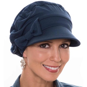 May include: A navy blue slouchy hat with a wide brim and a bow detail. The hat is made of a soft, comfortable fabric and is perfect for everyday wear.