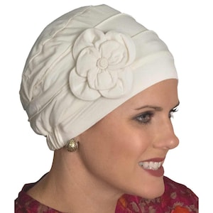 May include: A white cotton chemo cap with a large white fabric flower on the side.