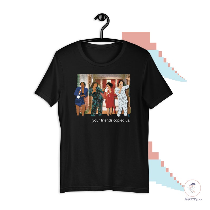 May include: Black t-shirt with a graphic of five people in pajamas standing in a hallway. The text "your friends copied us." is printed below the graphic.