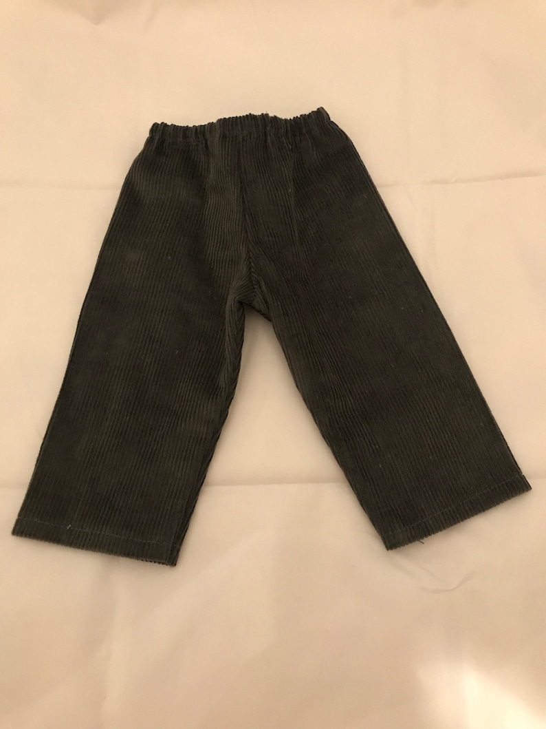 May include: A pair of dark grey corduroy trousers with an elastic waistband.